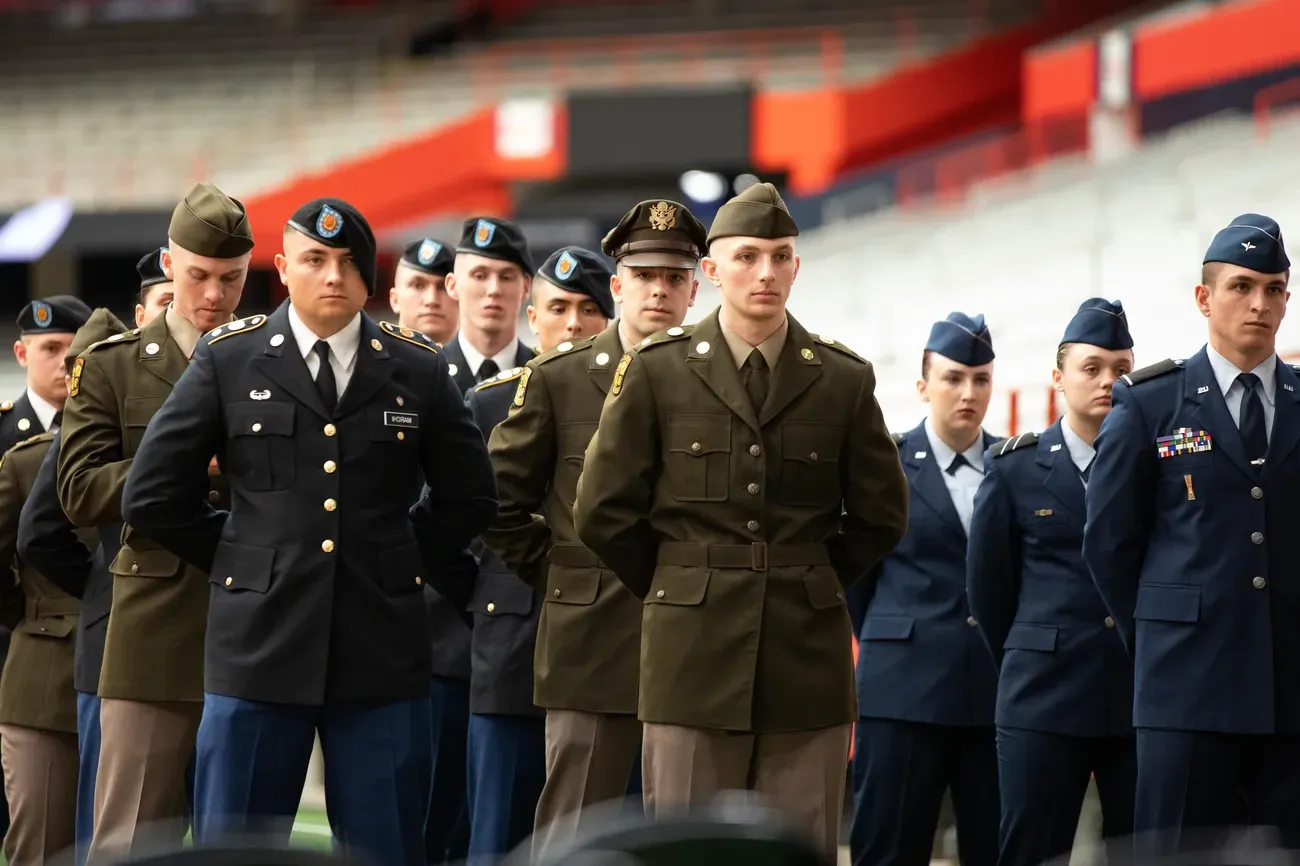 Army ROTC students and Air Force standing at attention wearing blue uniform at Chancellors Annual Review.